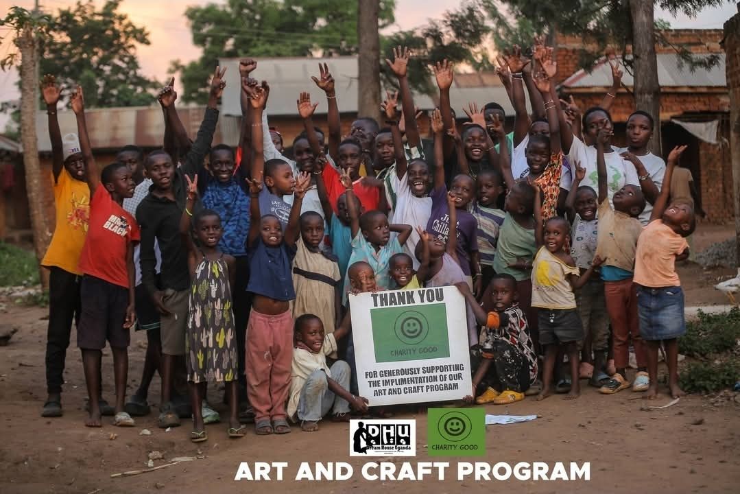 Children working together at a table in the Art and Craft Program workshop in Uganda