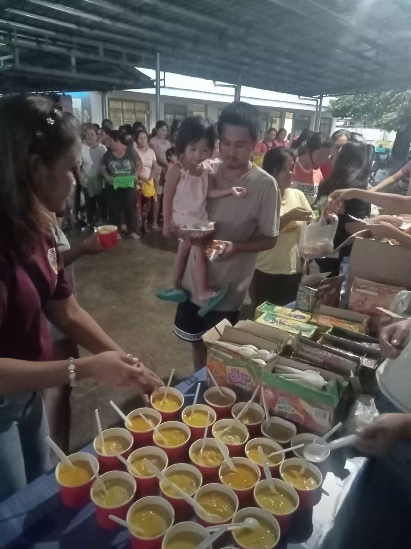 A father and daughter collecting their cups. The Philippines, September 2026.